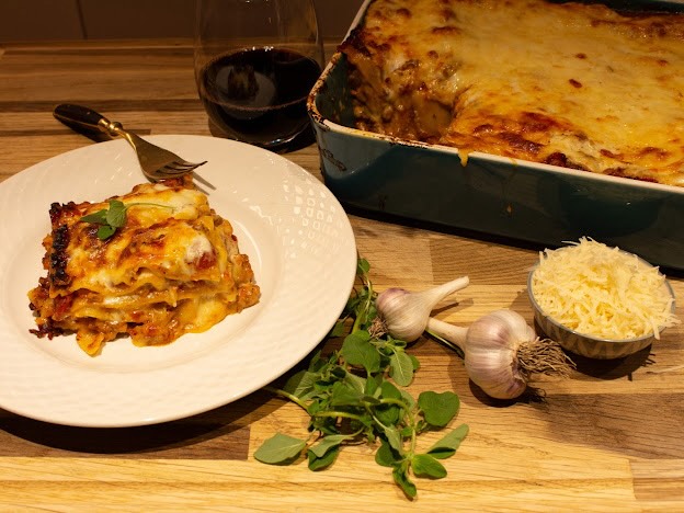 Plated lasagna with wine and garlic